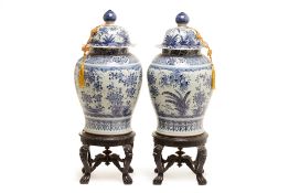 A PAIR OF LARGE BLUE & WHITE JARS AND COVERS ON STAND