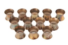 A SET OF TWELVE THAI SILVER NAPKIN RINGS