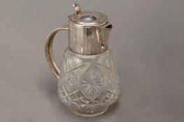 A SILVER MOUNTED CUT GLASS LEMONADE OR ICED WATER JUG