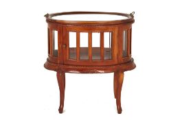 A GLAZED TEAK TRAY TABLE