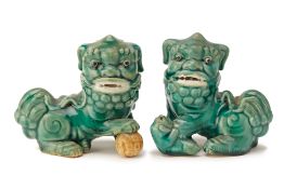 A PAIR OF GREEN GLAZED FOO DOGS