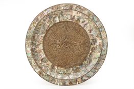 A MEXICAN ABALONE SHELL AND BRASS AZTEC CALENDAR PLATE