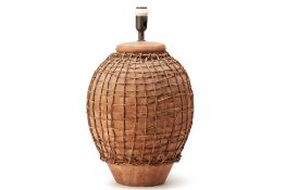 A LARGE WICKER BOUND POTTERY LAMP