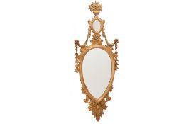 A CARVED GILTWOOD WALL MIRROR