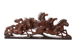 A HARDWOOD CARVING OF GROUP OF GALLOPING HORSES