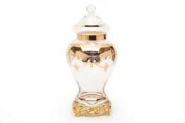 AN ITALIAN GILT DECORATED GLASS JAR AND COVER ON STAND