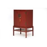 A RED LACQUER CABINET ON STAND