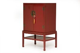 A RED LACQUER CABINET ON STAND