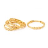 A SET OF FOUR GOLD BANGLES