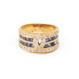 A SAPPHIRE AND DIAMOND BAND RING
