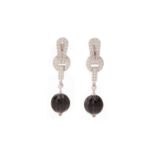 A PAIR OF CARTIER DIAMOND, ONYX AND RUBY 'AGRAFE' EARRINGS