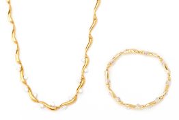 A GOLD AND DIAMOND NECKLACE AND BRACELET