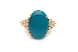 A TURQUOISE CABOCHON AND DIAMOND RING