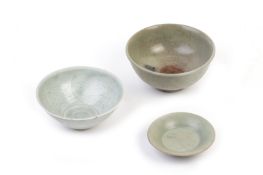 TWO CELADON BOWLS AND A SMALL DISH