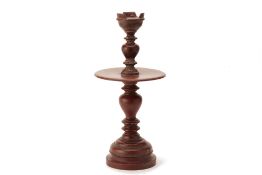 A RED PAINTED WOODCANDLESTICK