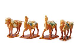 A PAIR OF SANCAI GLAZED CAMELS & A PAIR OF HORSES