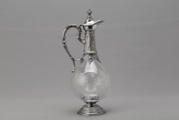 A SILVER MOUNTED GLASS CLARET JUG