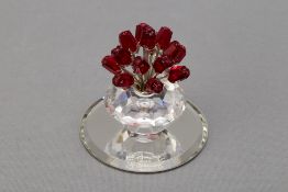 A SWAROVSKI CRYSTAL VASE OF RED ROSES