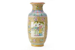 A CHINESE YELLOW GROUND FAMILLE ROSE VASE