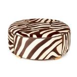 A LARGE CIRCULAR ZEBRA PRINT COWHIDE OTTOMAN