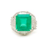 A PLATINUM STEP CUT EMERALD AND DIAMOND RING