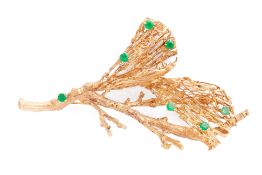 AN EMERALD BROOCH IN THE SHAPE OF A BRANCH