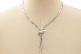 A DIAMOND AND WHITE GOLD NECKLACE WITH DIAMOND TASSEL