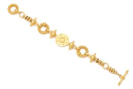 A YELLOW METAL AND DIAMOND CHARM BRACELET