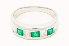 A PLATINUM, EMERALD AND DIAMOND RING