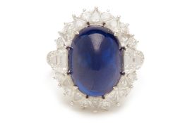 A CABOCHON BLUE SAPPHIRE AND DIAMOND RING