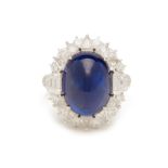 A CABOCHON BLUE SAPPHIRE AND DIAMOND RING