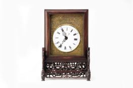 A CHINESE ROSEWOOD CLOCK ON STAND