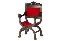 A SAVONAROLA STYLE CARVED WOOD CHAIR