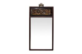 A MIRROR WITH CARVED WOODEN FRAME