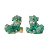 A PAIR OF GREEN GLAZED FOO DOGS