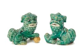 A PAIR OF GREEN GLAZED FOO DOGS