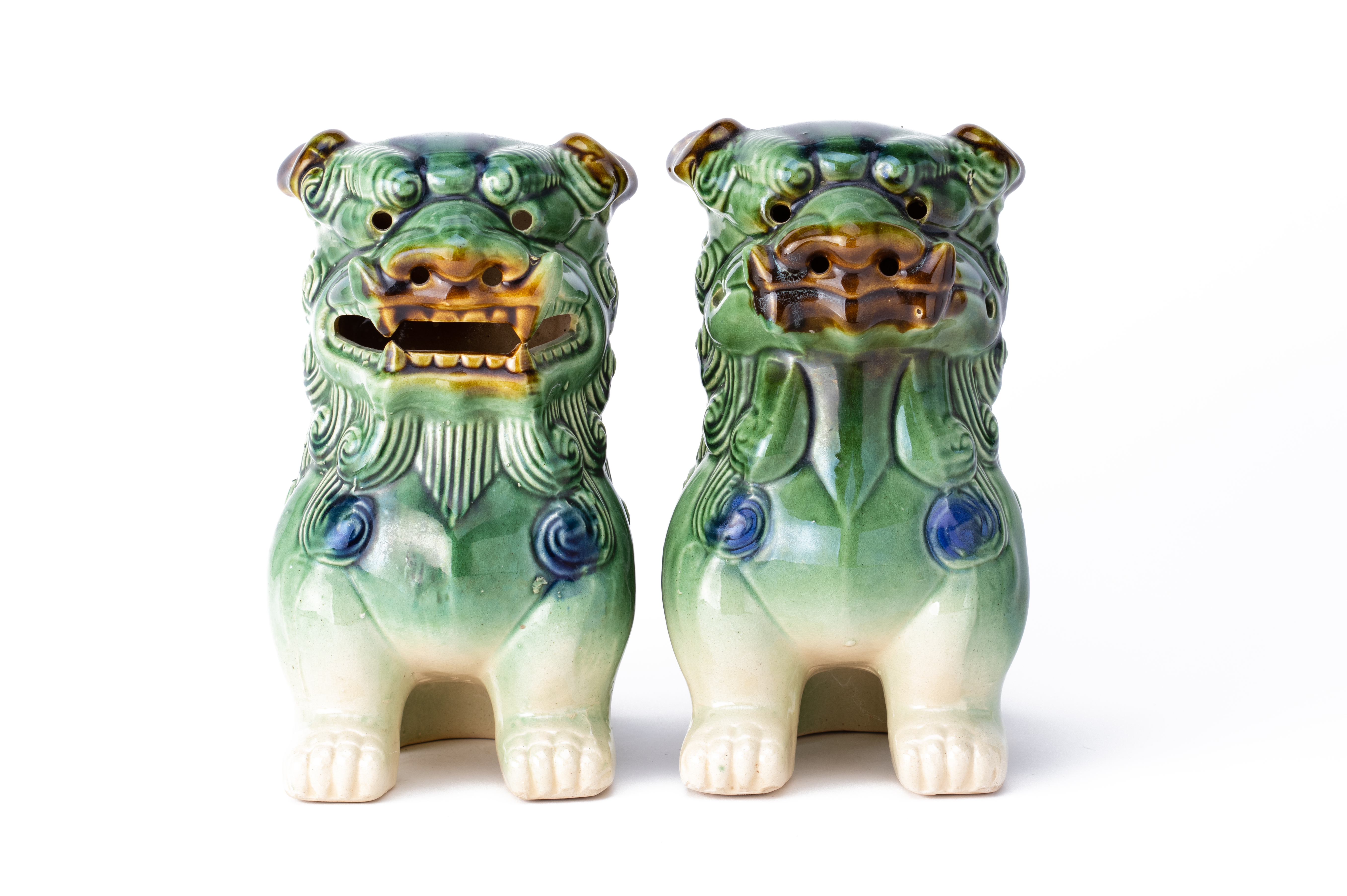 A PAIR OF GREEN GLAZED DOGS OF FO