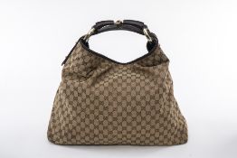 A GUCCI BROWN MONOGRAM HANDBAG