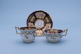 TWO SIMILAR TEA CUPS AND SAUCERS