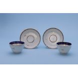 A PAIR OF SPIRALLY FLUTED TEA BOWLS AND SIMILAR SAUCERS