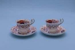 A PAIR OF IMARI COFFEE CUPS AND SAUCERS