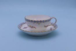 TWO SIMILAR TEA CUPS AND SAUCERS