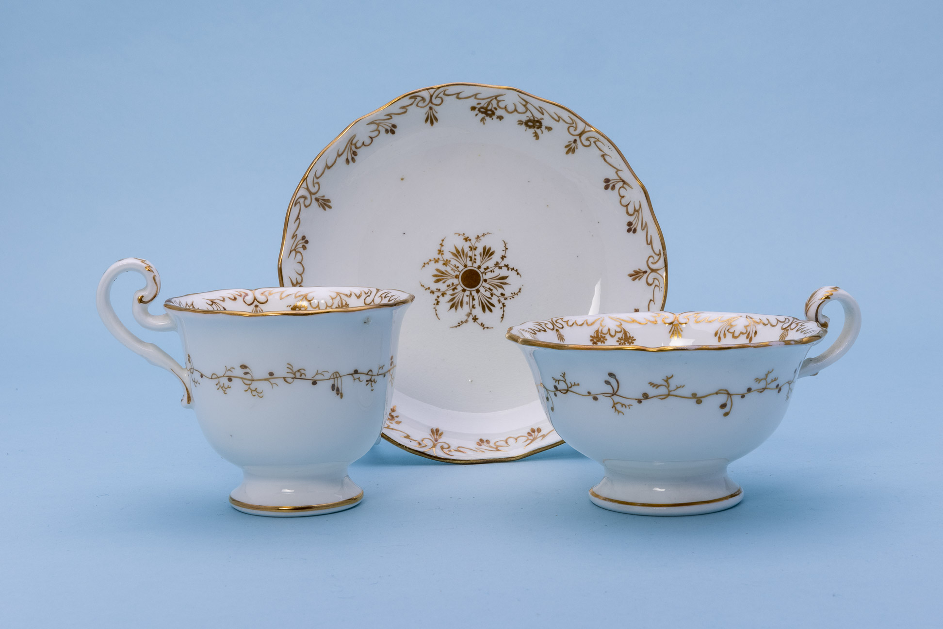 THREE GILT DECORATED TRIOS