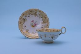 A GROUP OF THREE CUPS AND SAUCERS