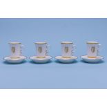 A SET OF FOUR ROYAL WORCESTER CHOCOLATE CUPS AND SAUCERS