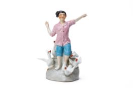 A CHINESE PORCELAIN PROPAGANDA FIGURE OF A GIRL WITH GEESE