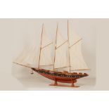A LARGE WOODEN MODEL OF A THREE MASTED SCHOONER