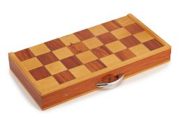 A FOLDING WOODEN CHESSBOARD AND PIECES