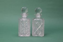 A PAIR OF CUT GLASS SQUARE SECTION DECANTERS
