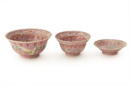 A PERANAKAN PINK-GROUND RICE BOWL, TEA CUP AND SAUCER